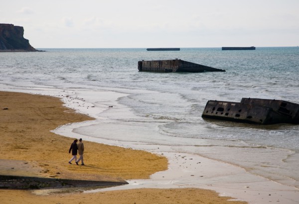 The Beach at Arromanches, Normandy with some of the remains of the Mulberry Harbour used in the 1944 Normandy Landings