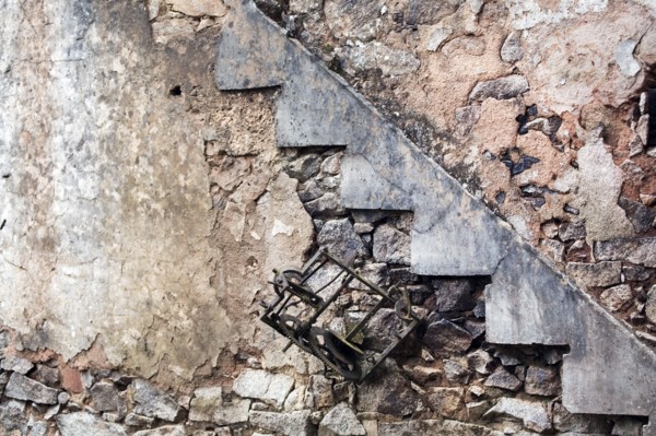 Destroyed the French village Oradour-sur-Glane. Interior with ruins of a clock and stair case.