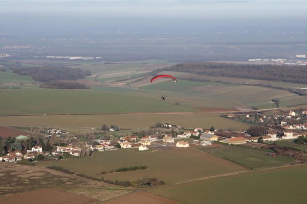 Aerial view of a paramotor flying over the commune of Soindres in the Yvelines department (78200), Ile-de-France region, France - January 03, 2010
