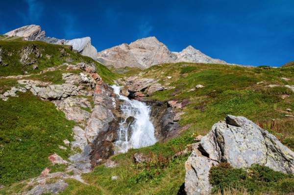 Alpine waterfall on the GR Tour du Mont-Blanc trail to the Robert Blanc refuge, Savoie (73), Auvergne-Rhone-Alpes, France