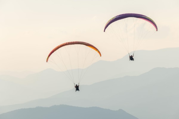 Paragliding flight in the air over the mountains. Drôme, France.