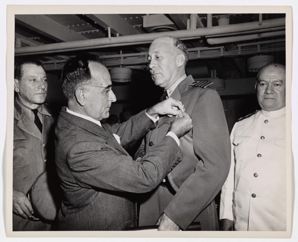 Coast Guard Skipper Decorated by Brazilian President. Coast Guard Captain George W. McKean, Skipper of a troop transport in the Atlantic, is presented with the Medal of Military Merit by President Get...