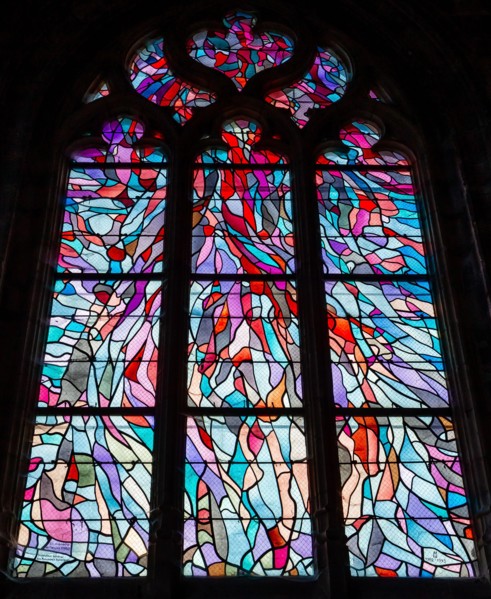 ABBEVILLE, SOMME, FRANCE, JUNE 18, 2023 :  details of stained glasses windows in Saint Sepulcre church, by Alfred Manessier workshop, year 1989  to 19