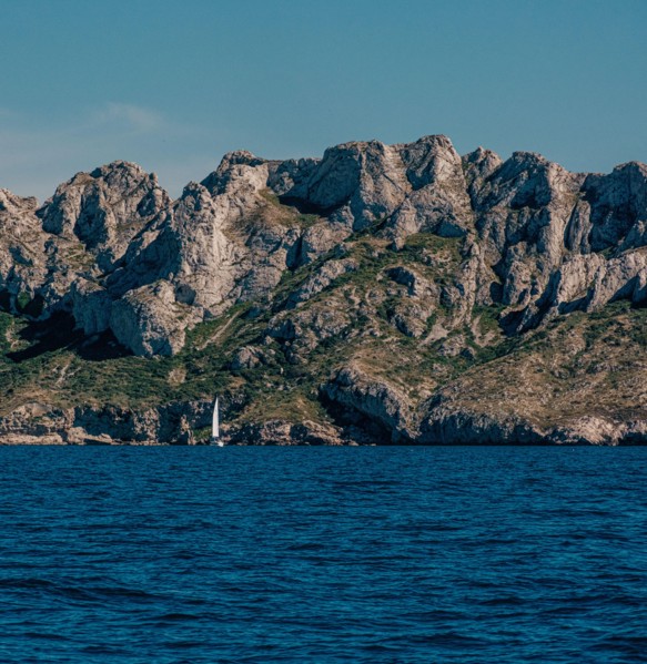 Steep rocky cliffs above a serene sea in The Calanques, Marseille