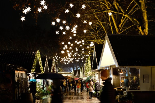 German Christmas market at night  with market stalls and illuminated stars
