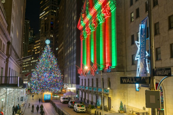 Christmas tree glows at front of NYSE during Pandemic of COVID-19 2020 NYC.