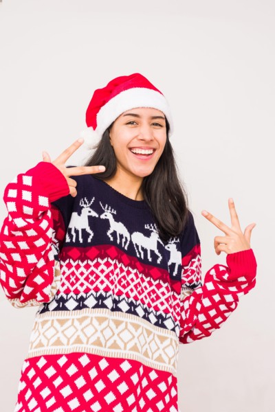 Christmas ugly sweater. Latin venezuelan woman wearing a fashion woolen xmas style