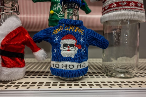 Ugly christmas sweater fitting a glass flask