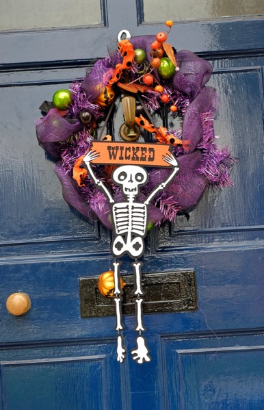 halloween wreath hanging on house front door
