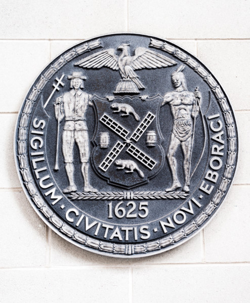 The seal of the City of New York on the side of a school in New York on Saturday, April 15, 2017. (© Richard B. Levine)
