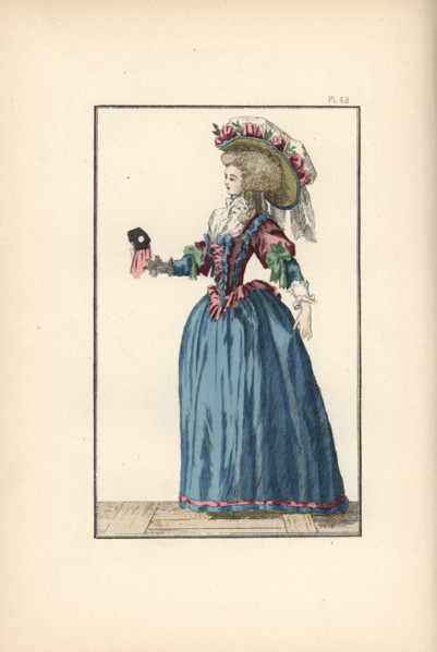 Woman in a ball gown, with chapeau topped with a pouf decorated with ribbons and laurel leaves, fichu, corset in English taffeta, and blue taffeta petticoat. In her hand is a black ball mask with pink...