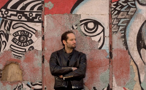 Jan 19, 2006; Mexico City, MEXICO; Mexican film maker, CARLOS REYGADAS' work is quintessentially Mexico City, here photographed in front of a decomposing mural on the streets of the historical center ...