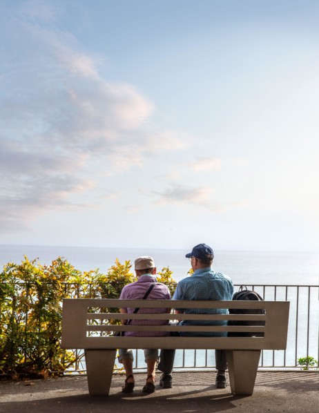 Rear view of senior couple sitting and look at the endless horizon