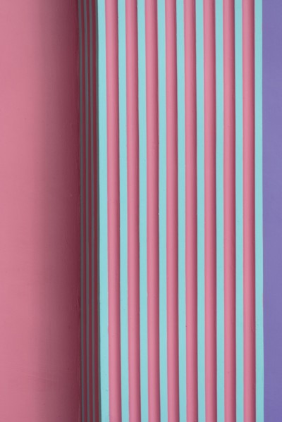 vertical pink green purple striped concrete or cement wall architecture abstract background