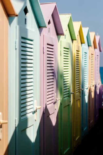Group of colorful beach cabins in Italy.