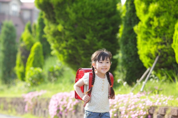 Girl walking with school bag on her back