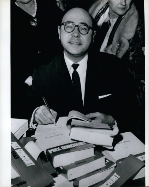 Nov. 11, 1965 - Jacques Borel: Winner of the Goncourt Literary Prize for his book ''Adoration'' -signing his book. (He is English teacher in a Paris school)