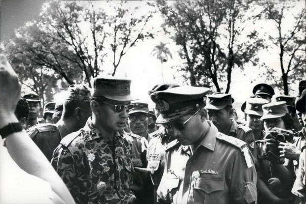 Feb. 24, 2012 - Grief exchanged - Maj. General Suharto (left) newly appointed Army Chief of Staff in Indonesia, talks with fellow officer outside Army Headquarters in Djakarta prior to funeral service...