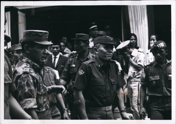1965 - General Abdul Haris Nasuton, Centre, griefstricken, as he leaves his house in Djakarta for funeral of his 5-year-old daughter who was fatally wounded in the aborted communist coup of Oct 1, 196...