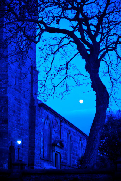 Old church at night under full moon