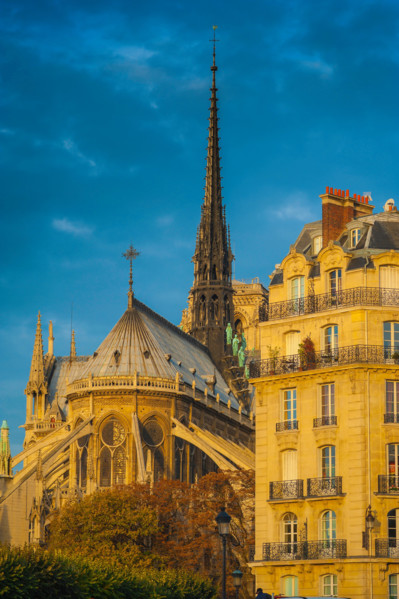 Paris architecture, the east end of Notre Dame Cathedral alongside a typical 19th century apartment building on the Ile de la Cite in Paris, France.
