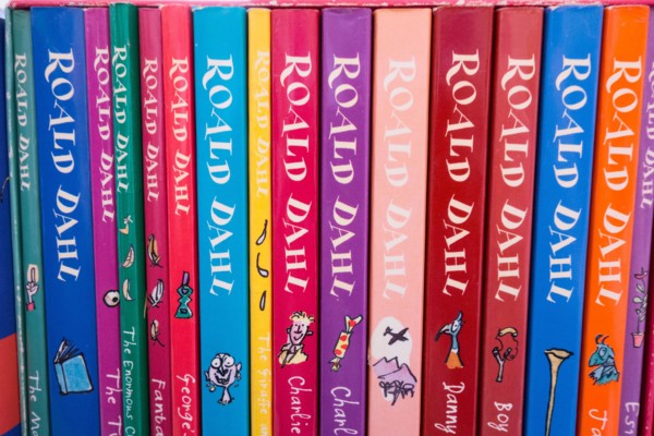 Closeup of colourful Roald Dahl book covers, spines, illustrations and artwork