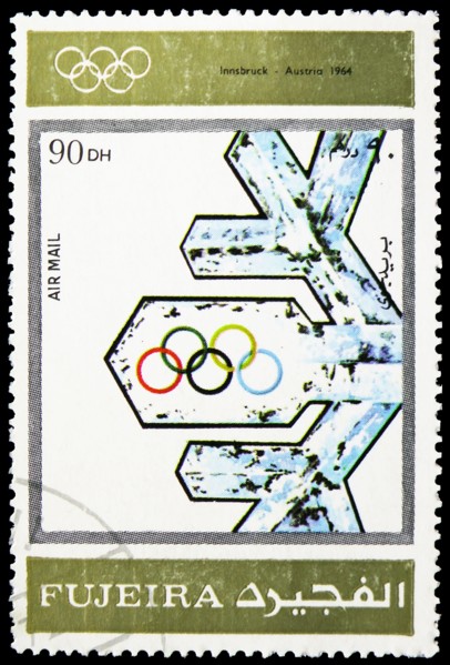 MOSCOW, RUSSIA - MARCH 23, 2019: Postage stamp printed in United Arab Emirates, Fujairah, shows Innsbruck 1964, Winter Olympics 1924-1972, Advertising