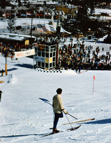 1960 Winter Olympics in Squaw Valley California: One legged skier watching skiers on the slalom course