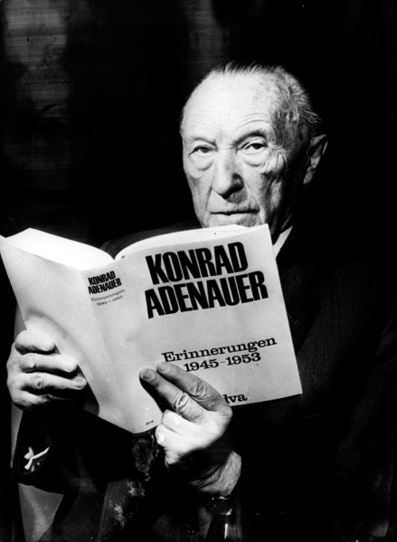 Konrad Adenauer holding an edition of his memoirs