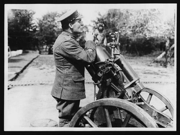 A mascot of the trench mortar school posed on a German trench mortar during World War I. Trench mortars were essential in targeting enemy positions on the front lines.