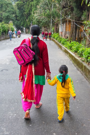 Parent taking kid to school, Gangtok, Sikkim, India