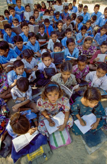 India, Rajasthan, primary school class having lessons outside between Jodhpur and Jaipur.