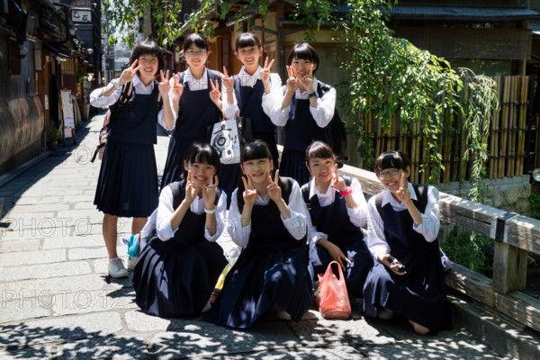 Kyoto, Japan - May 18, 2017: Group of pupils in school uniform on a trip in Kyoto are posing for a picture