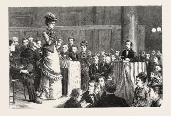 A SPELLING BEE: A FAIR COMPETITOR PUZZLED. ENGRAVING 1876, UK, britain, british, europe, united