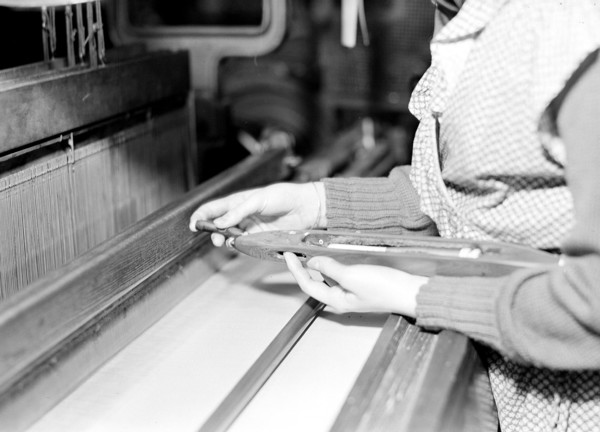 Paterson, New Jersey - Textiles. Weaver threading shuttle, March 1937, Lewis Hine, 1874 - 1940, was