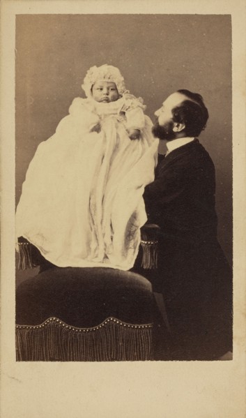 [Baby in a bonnet and a long gown]