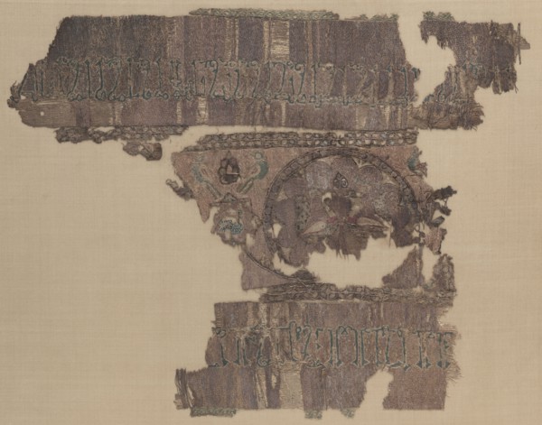Fragment with peacocks and inscription, 1000-1100s. Iraq, probably Baghdad, Seljuq period. Plain