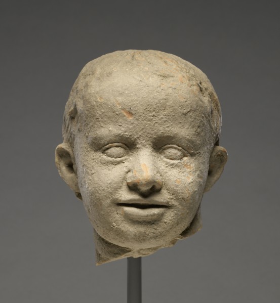 Head of a Child; Tarentum, Taras, South Italy; 300 - 200 B.C; Terracotta with clay slip; 13.5 × 11.5 cm, 5 5,16 × 4 1,2 in