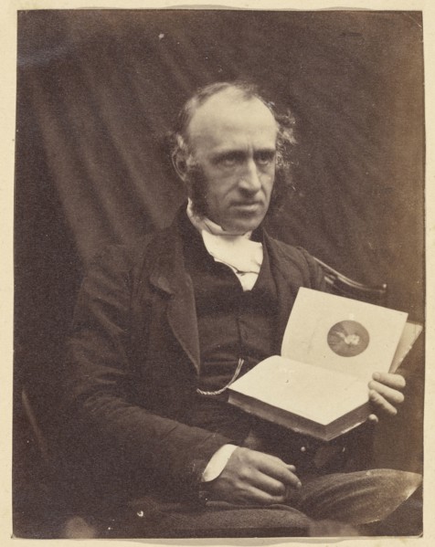 Portrait of Seated Man with a Book; British; 1870 - 1875; Albumen silver print