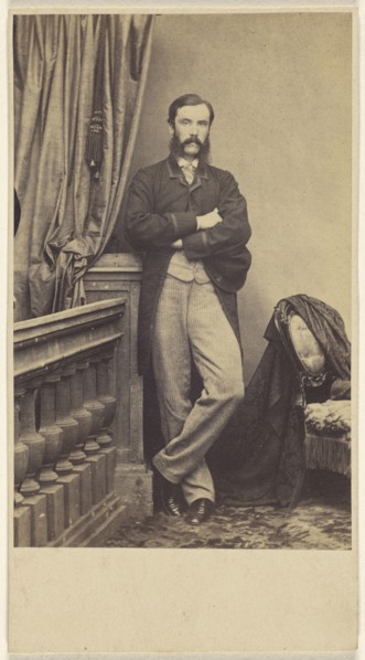 man with moustache & muttonchops, standing with arms crossed; about 1865; Albumen silver print