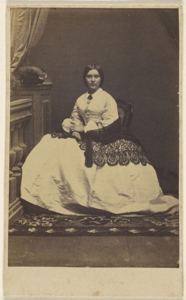 woman in a white dress with dark shawl, seated; about 1865; Albumen silver print