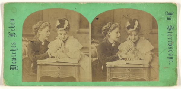 Mother and daughter looking at a book, leaning on a table; German; 1860s; Albumen silver print