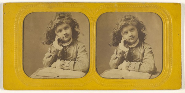 Little girl seated with hand on cheek, open book in front of her; 1855 - 1860; Hand-colored Albumen silver print