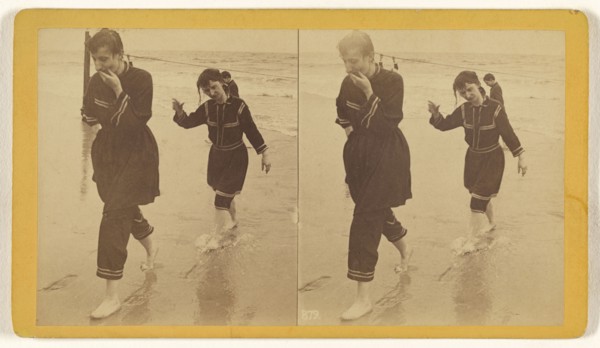 Man and woman dressed in similar costumes walking across beach; about 1865; Albumen silver print