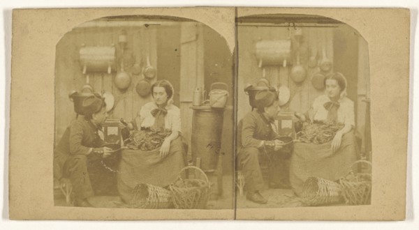 Woman seated in kitchen with foodstuffs on her lap, pouring wine into a pot being held by a man wearing a hat; French