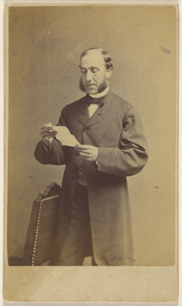 Man with muttonchops reading a letter, standing; J.A. Whipple, American, 1822 - 1891, about 1865; Albumen silver print
