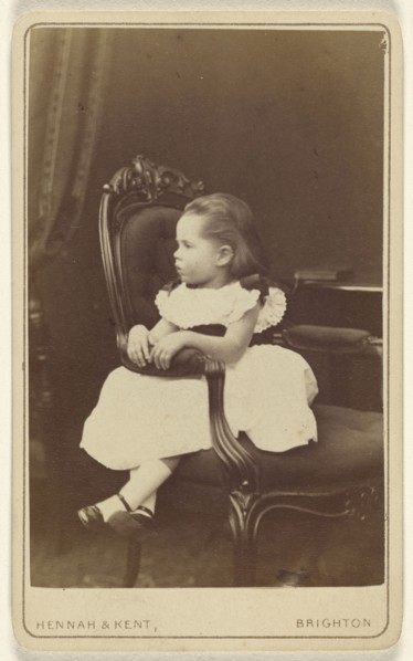 Little girl seated sideways in an armchair; Hennah & Kent; about 1870; Albumen silver print