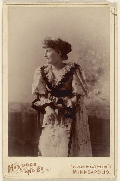 woman in profile, leaning on a chair, holding a feather fan; Murdock and Company; about 1890; Gelatin silver print