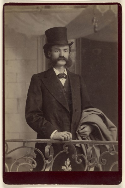 man with moustache and muttonchops wearing fancy clothes and a top hat; about 1885; Albumen silver print
