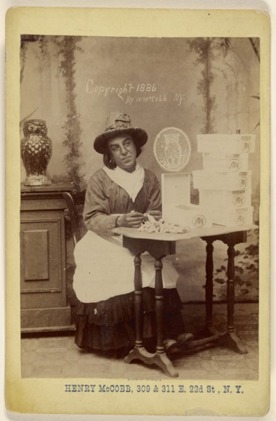 man dressed as a woman seated at a table wrapping chocolates; Henry McCobb, American, active New York, New York 1880s, 1886